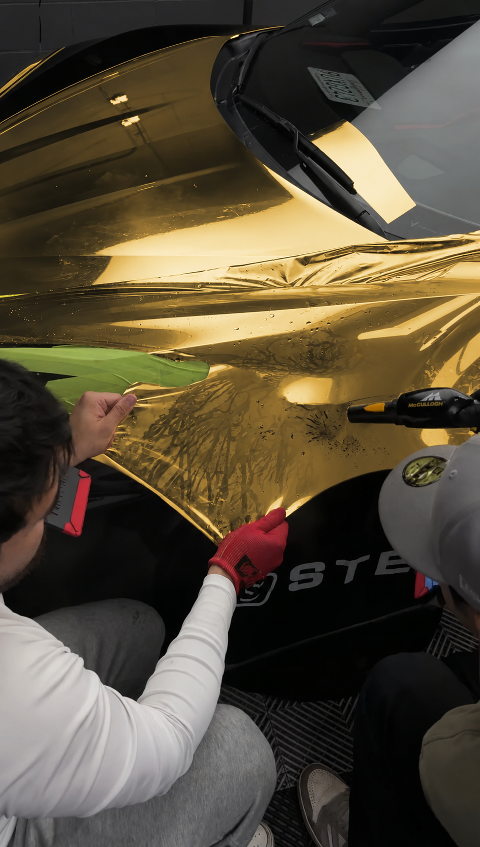 Installer applying satin gold vinyl film